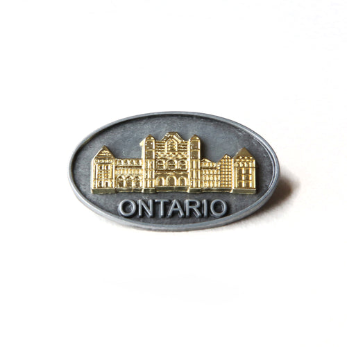 Oval pewter pin with gold coloured insert of the Legislative Building 